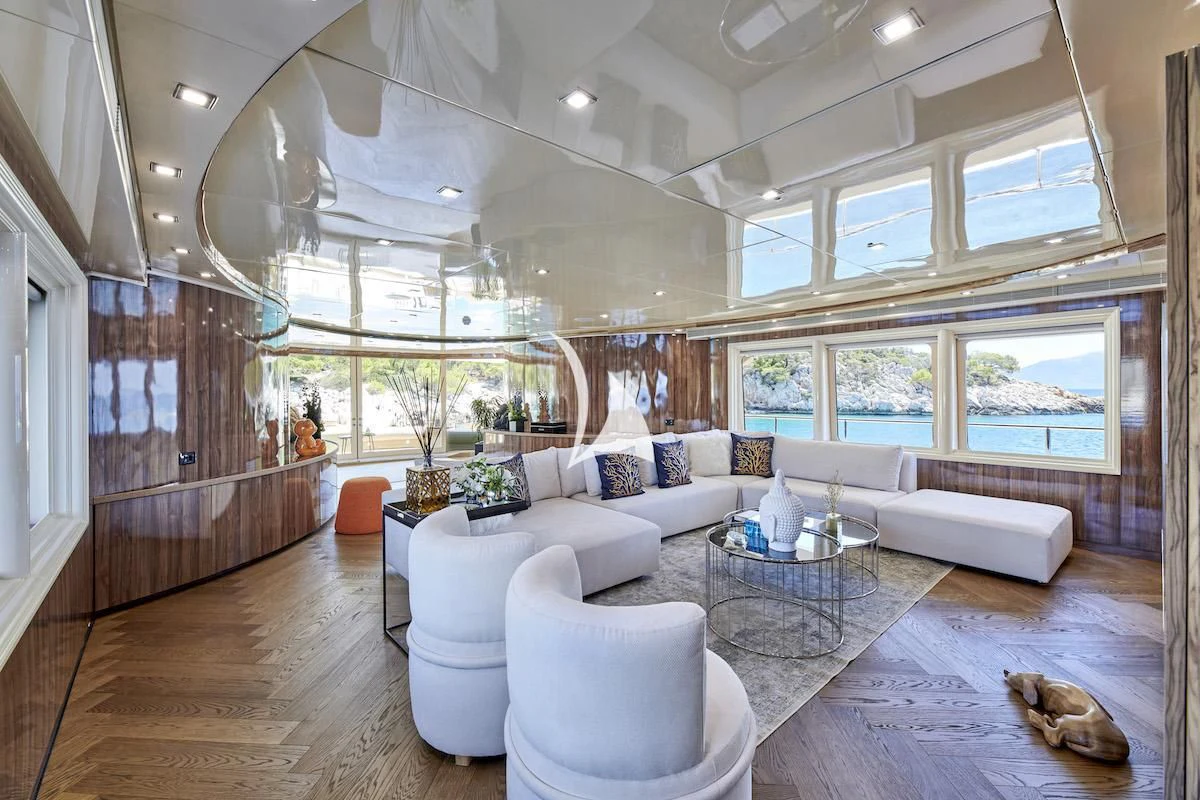 a large living room with white furniture aboard PROMETHEUS I Yacht for Charter