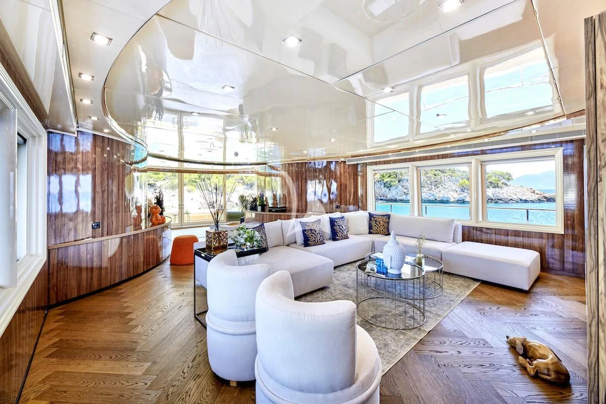 a living room with a large window aboard PROMETHEUS I Yacht for Charter