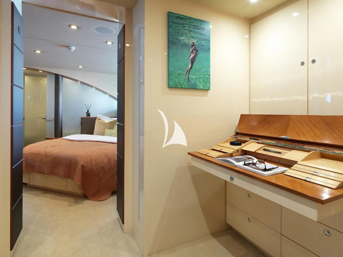a room with a desk and a bed aboard PROMETHEUS I Yacht for Charter