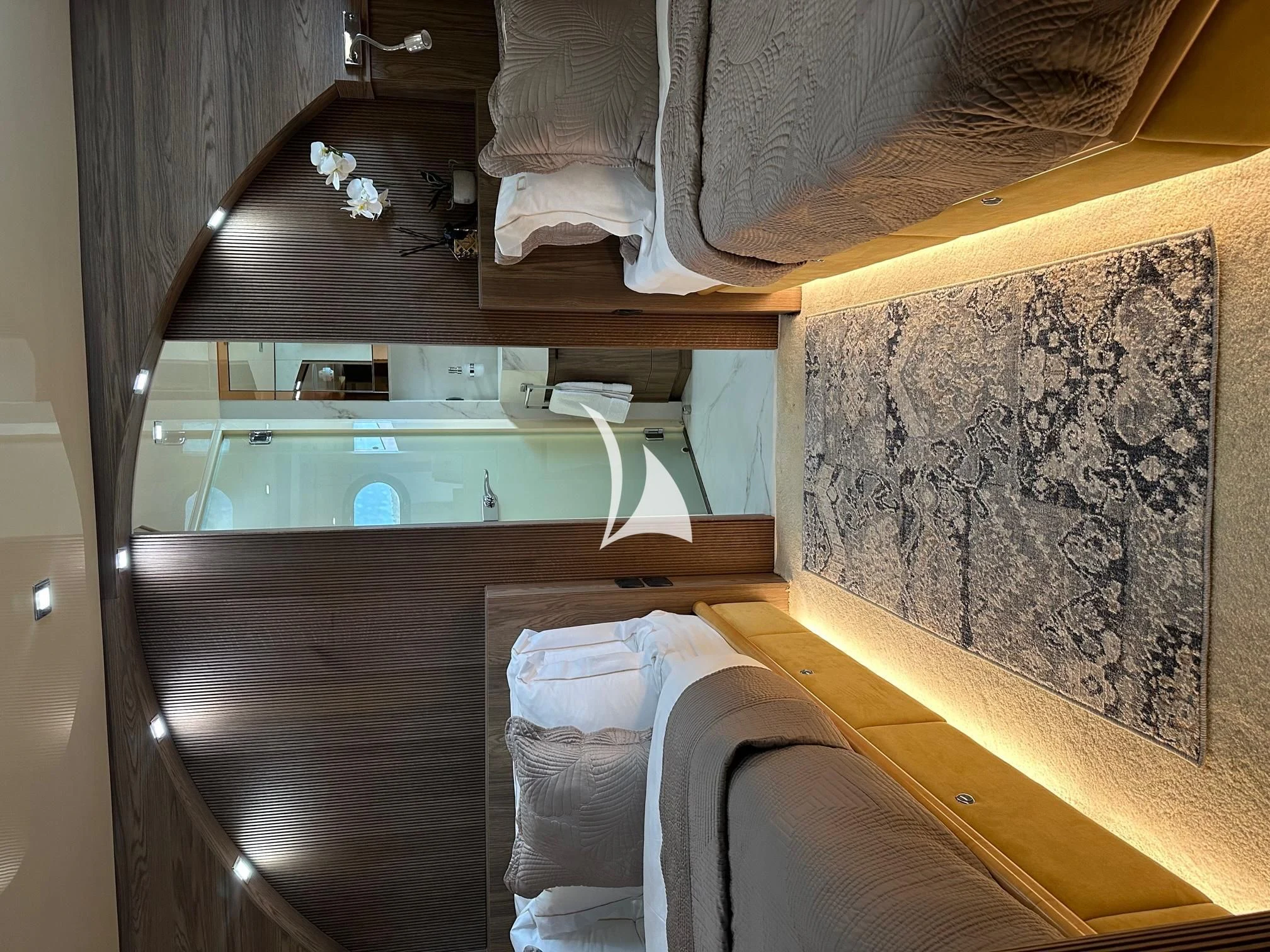 a room with a bed and a mirror aboard PROMETHEUS I Yacht for Charter