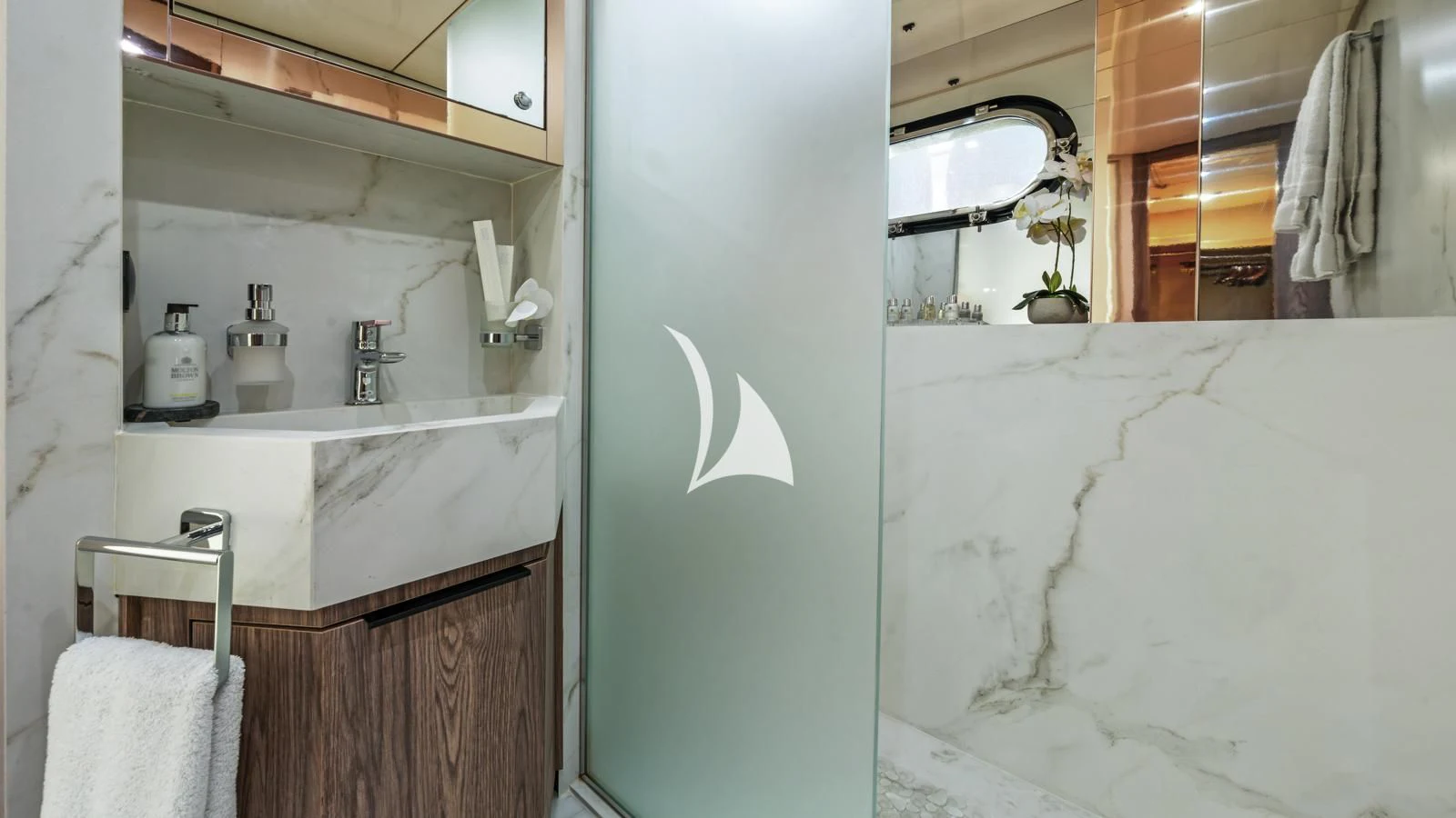 a bathroom with a sink and a mirror aboard PROMETHEUS I Yacht for Charter