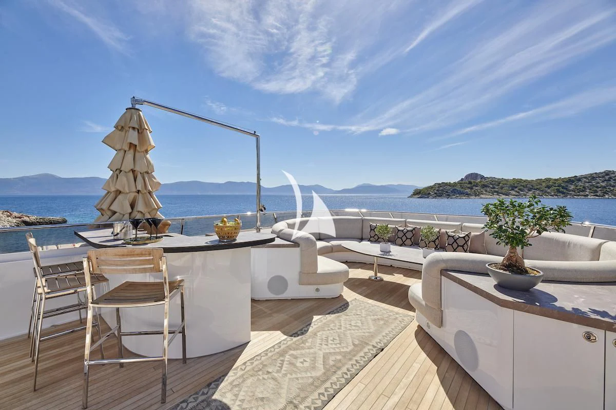 a table and chairs on a balcony aboard PROMETHEUS I Yacht for Charter