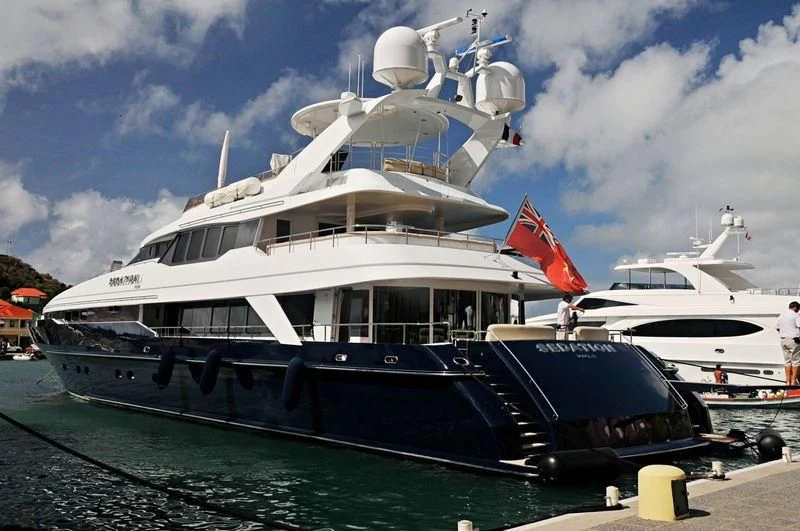 a large boat docked at a dock aboard PROMETHEUS I Yacht for Charter