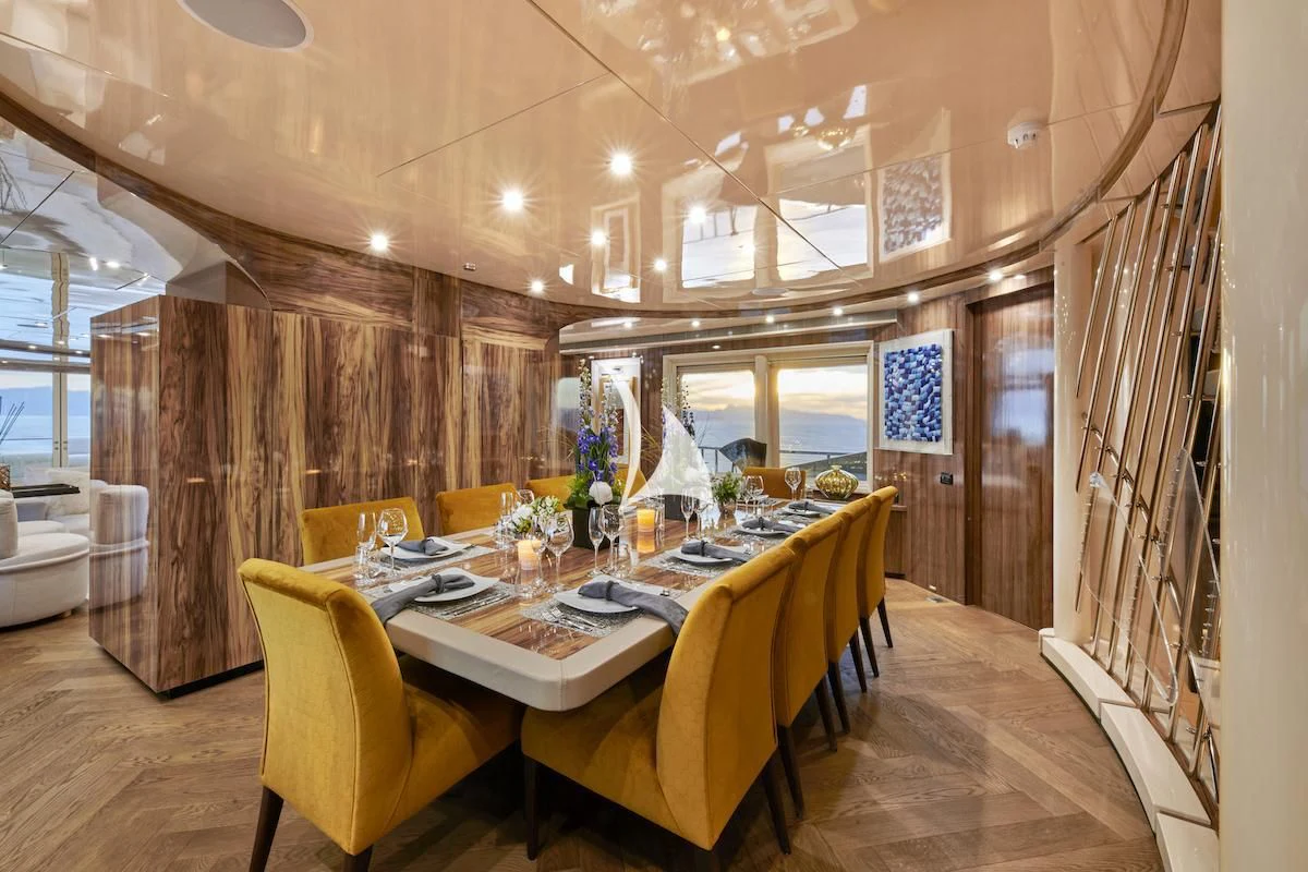 a dining room with a table and chairs aboard PROMETHEUS I Yacht for Charter