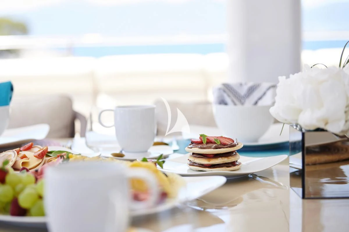 a plate of desserts on a table aboard PROMETHEUS I Yacht for Charter