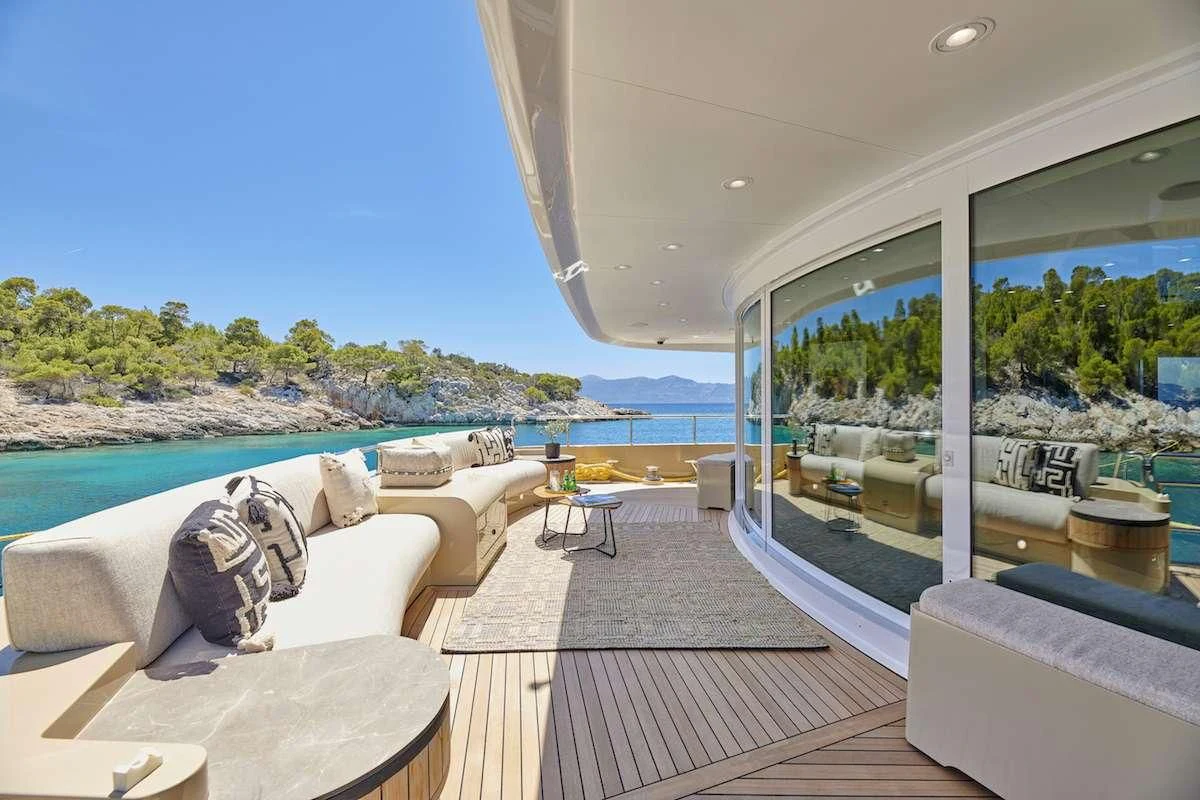 a living room with a large window aboard PROMETHEUS I Yacht for Charter