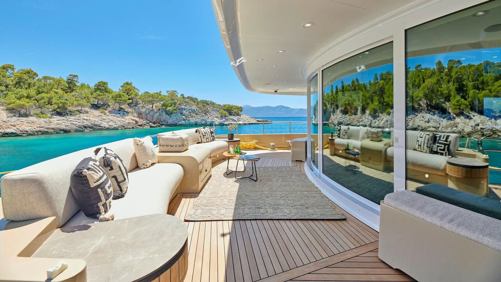 a living room with a large window aboard PROMETHEUS I Yacht for Charter