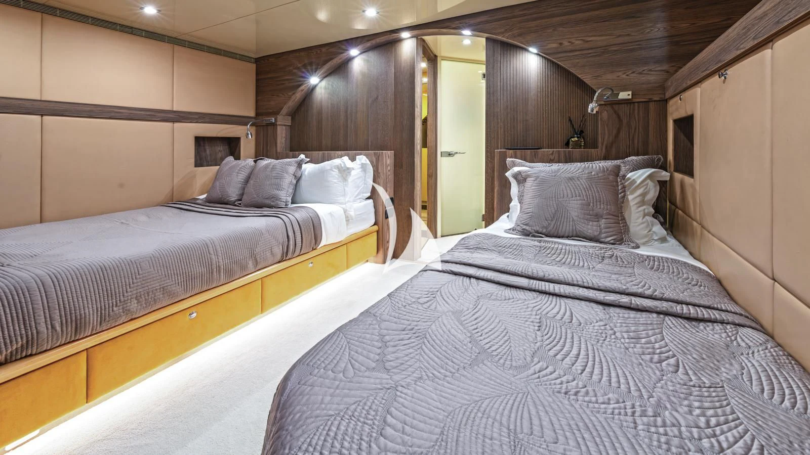 a room with beds and a mirror aboard PROMETHEUS I Yacht for Charter
