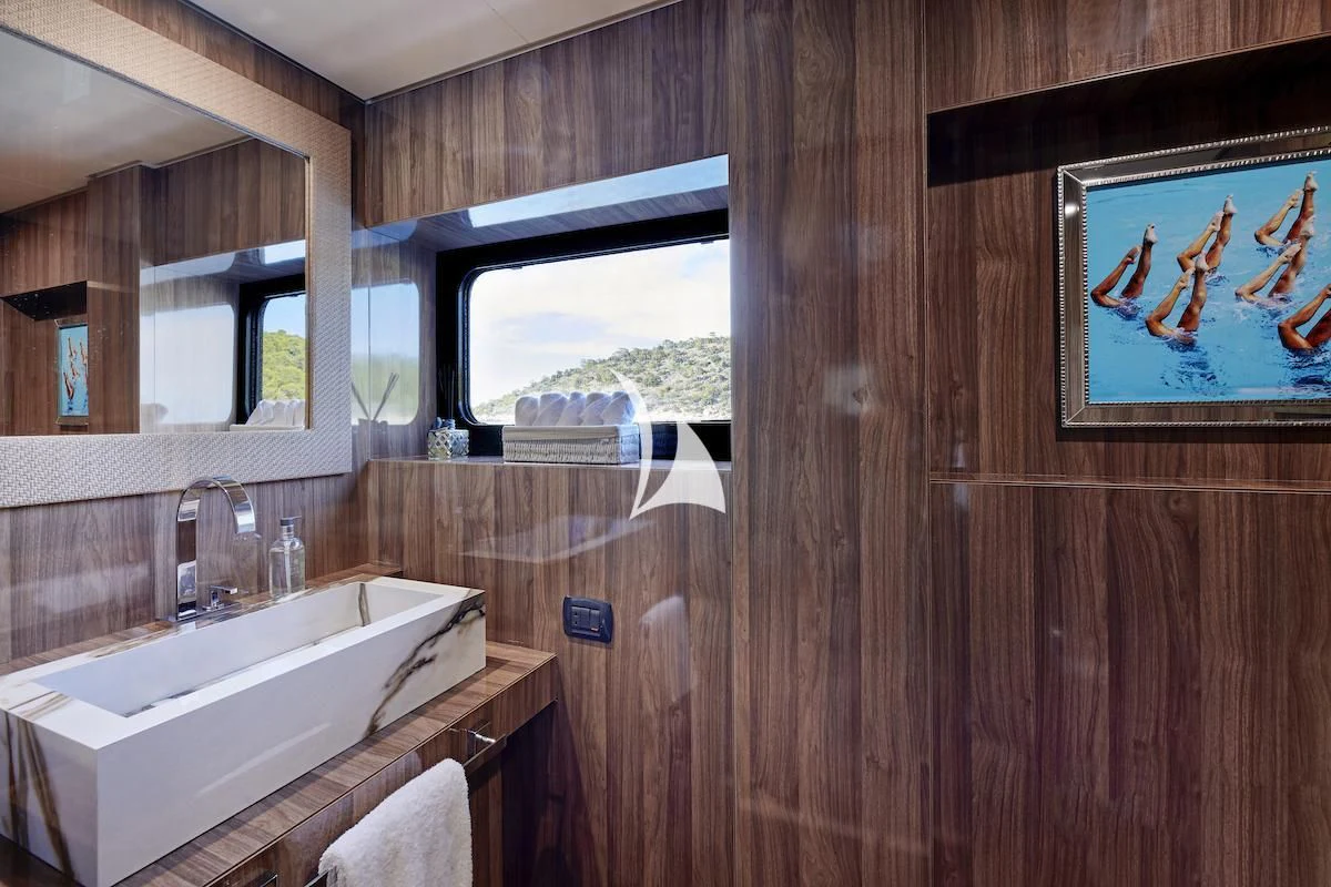 a bathroom with a wood wall aboard PROMETHEUS I Yacht for Charter