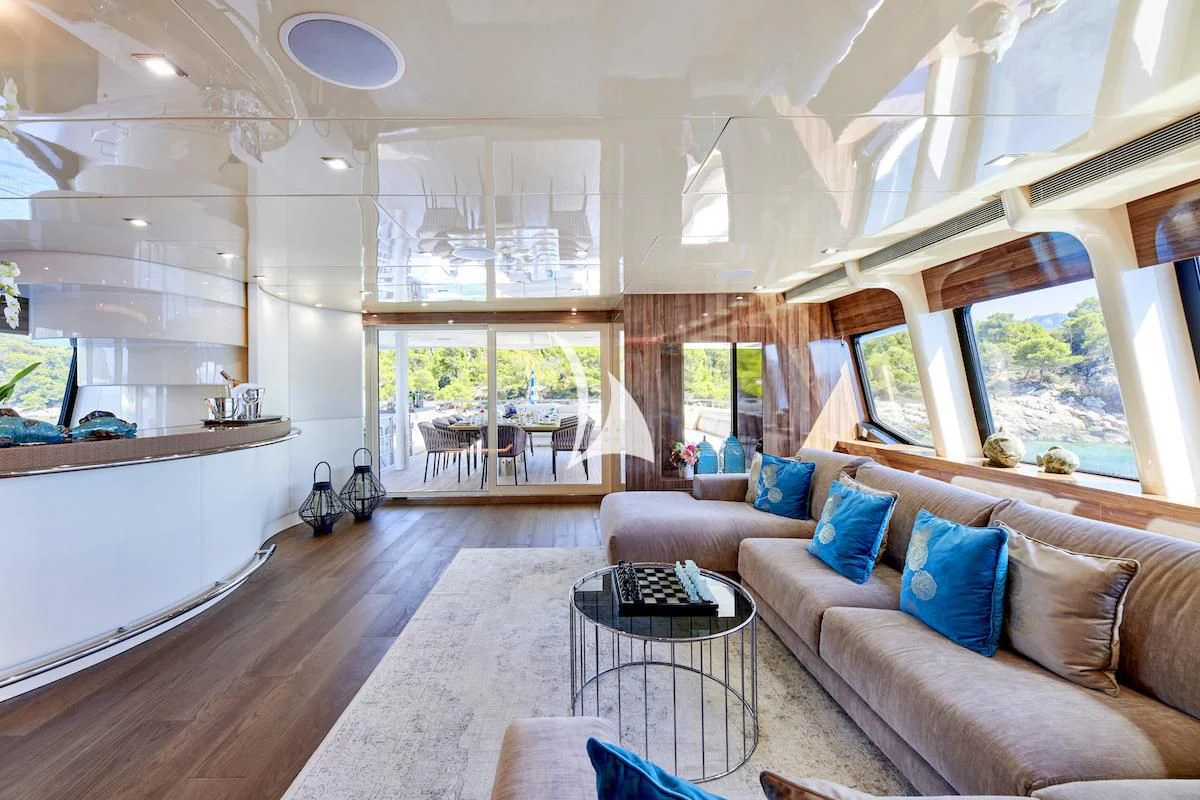 a living room with a large window aboard PROMETHEUS I Yacht for Charter