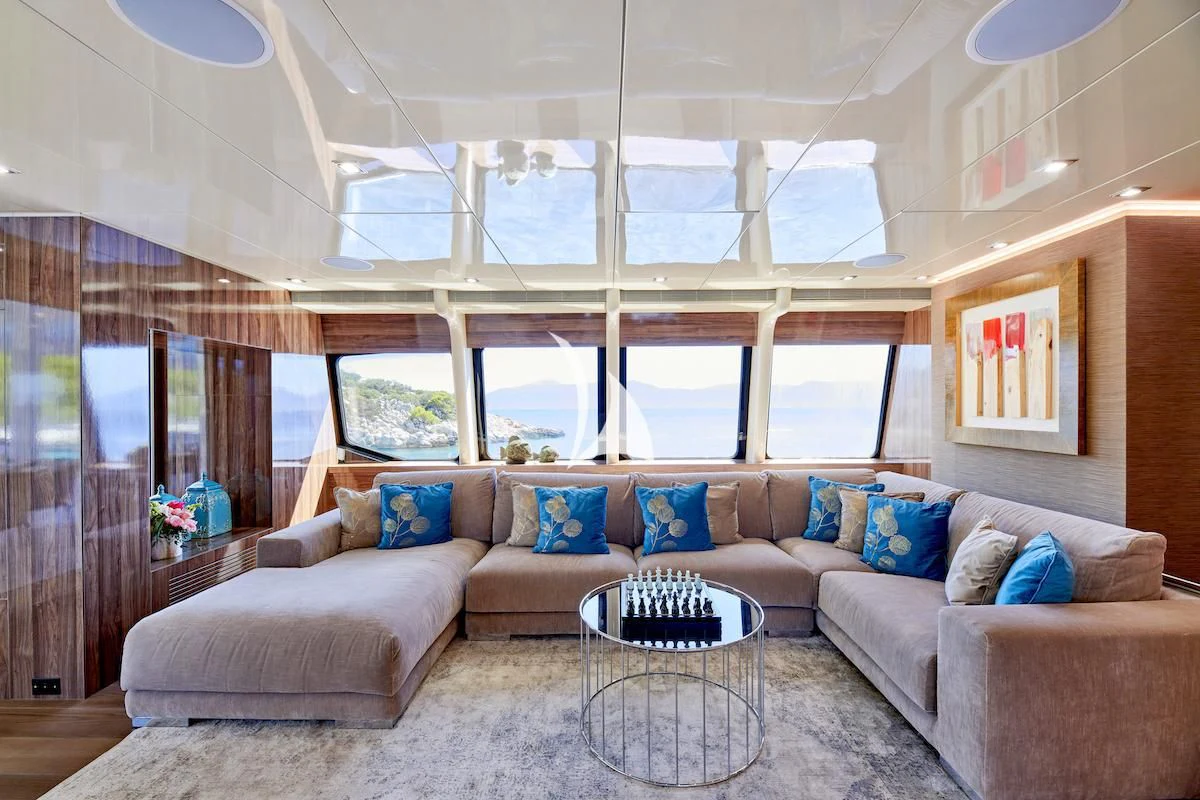 a living room with a couch and a table aboard PROMETHEUS I Yacht for Charter