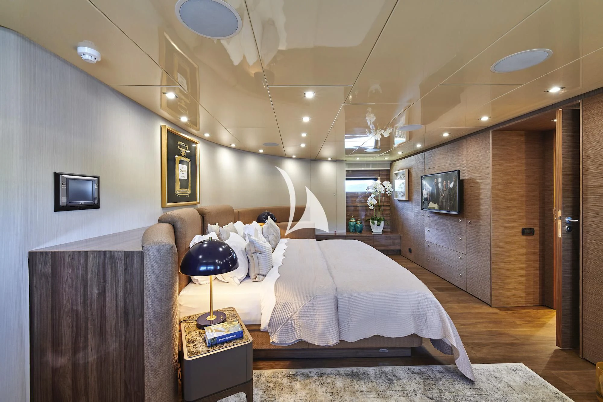a room with a bed and a television aboard PROMETHEUS I Yacht for Charter