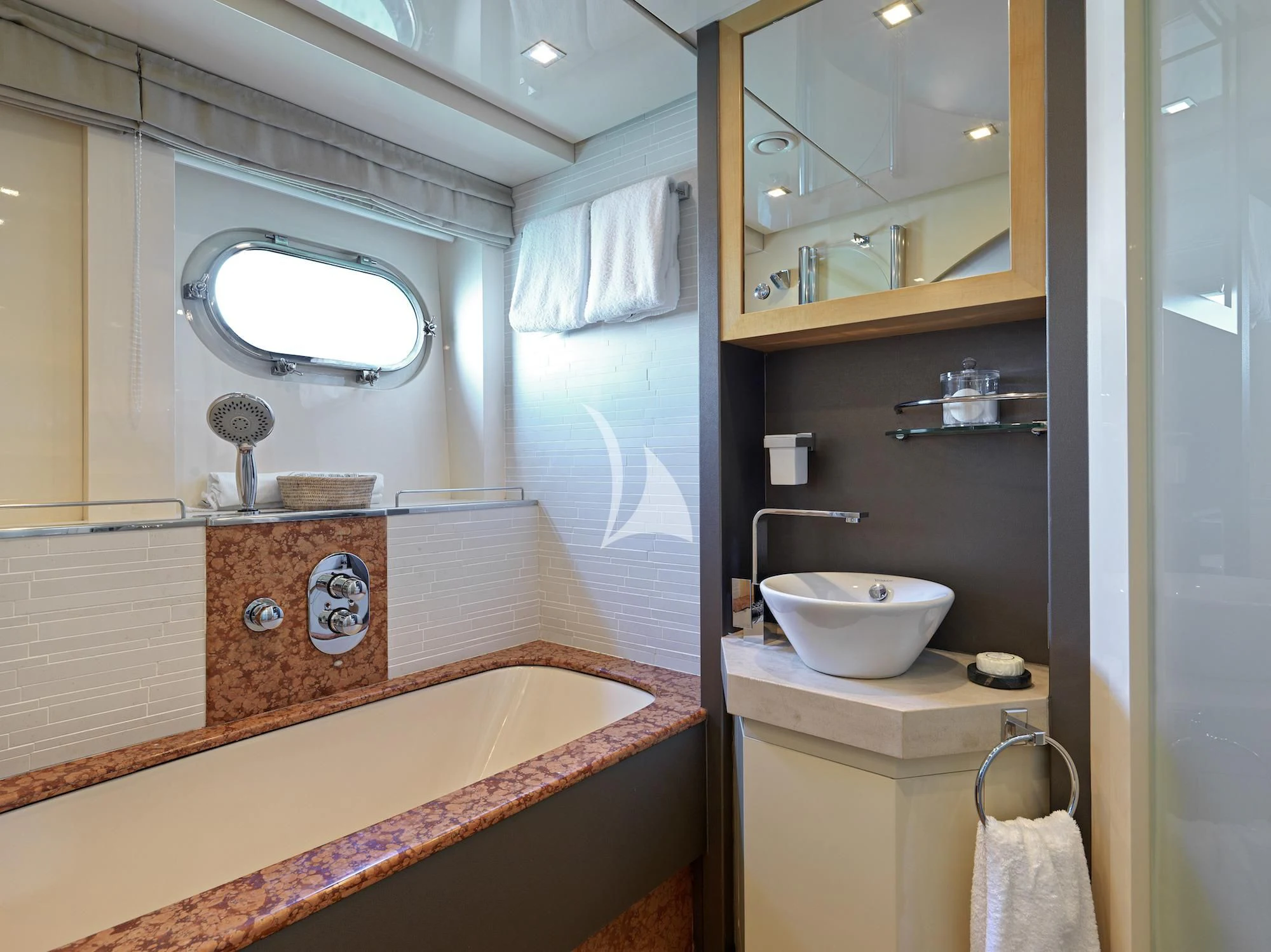 a bathroom with a sink and a mirror aboard PROMETHEUS I Yacht for Charter