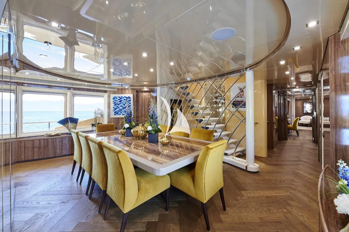 a room with a table and chairs aboard PROMETHEUS I Yacht for Charter