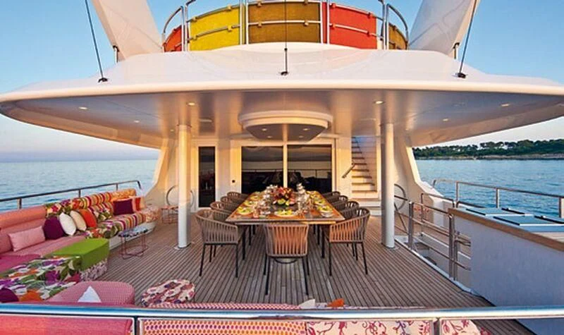 a patio with a table and chairs on it aboard PROMETHEUS I Yacht for Charter