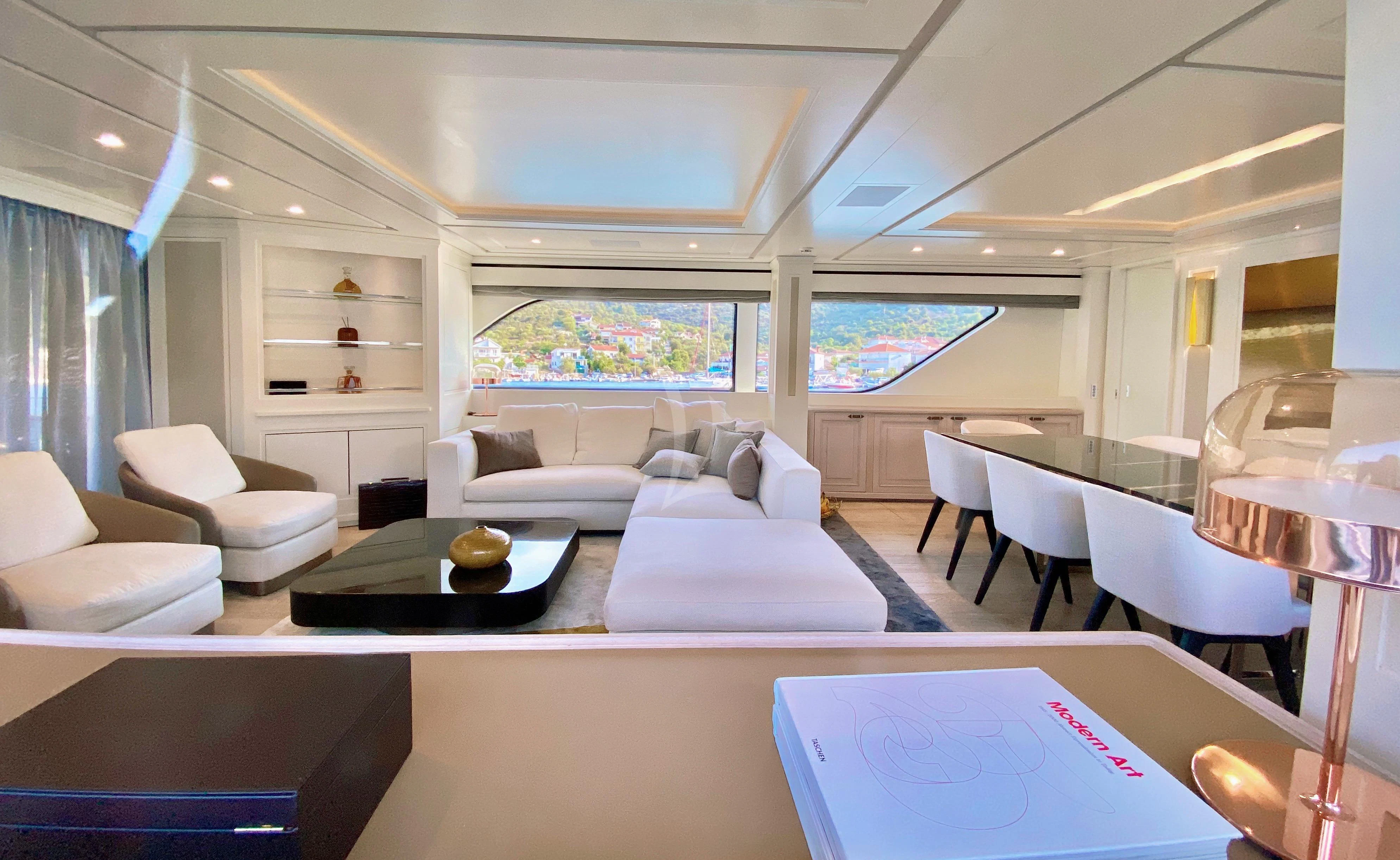 a room with a couch and a table and a tv aboard VALENTINA II Yacht for Sale