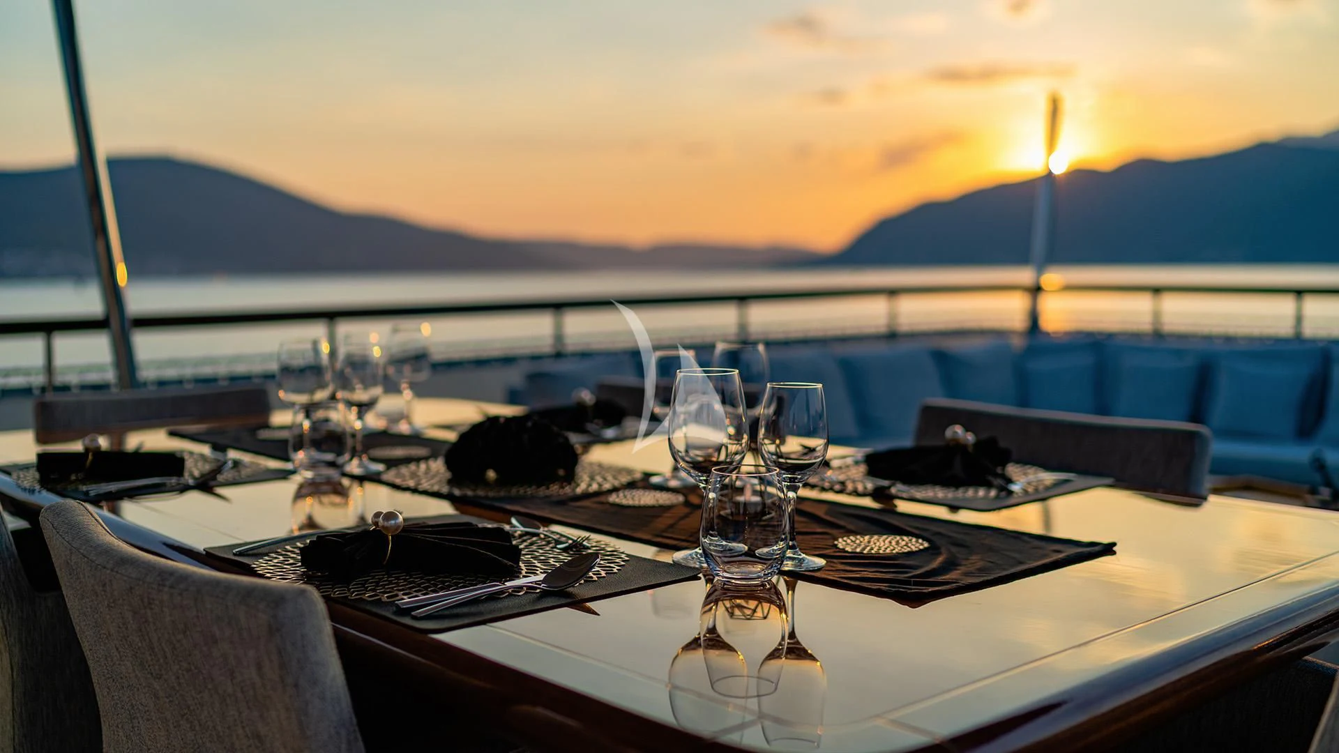 a table with wine glasses on it aboard VALENTINA II Yacht for Sale