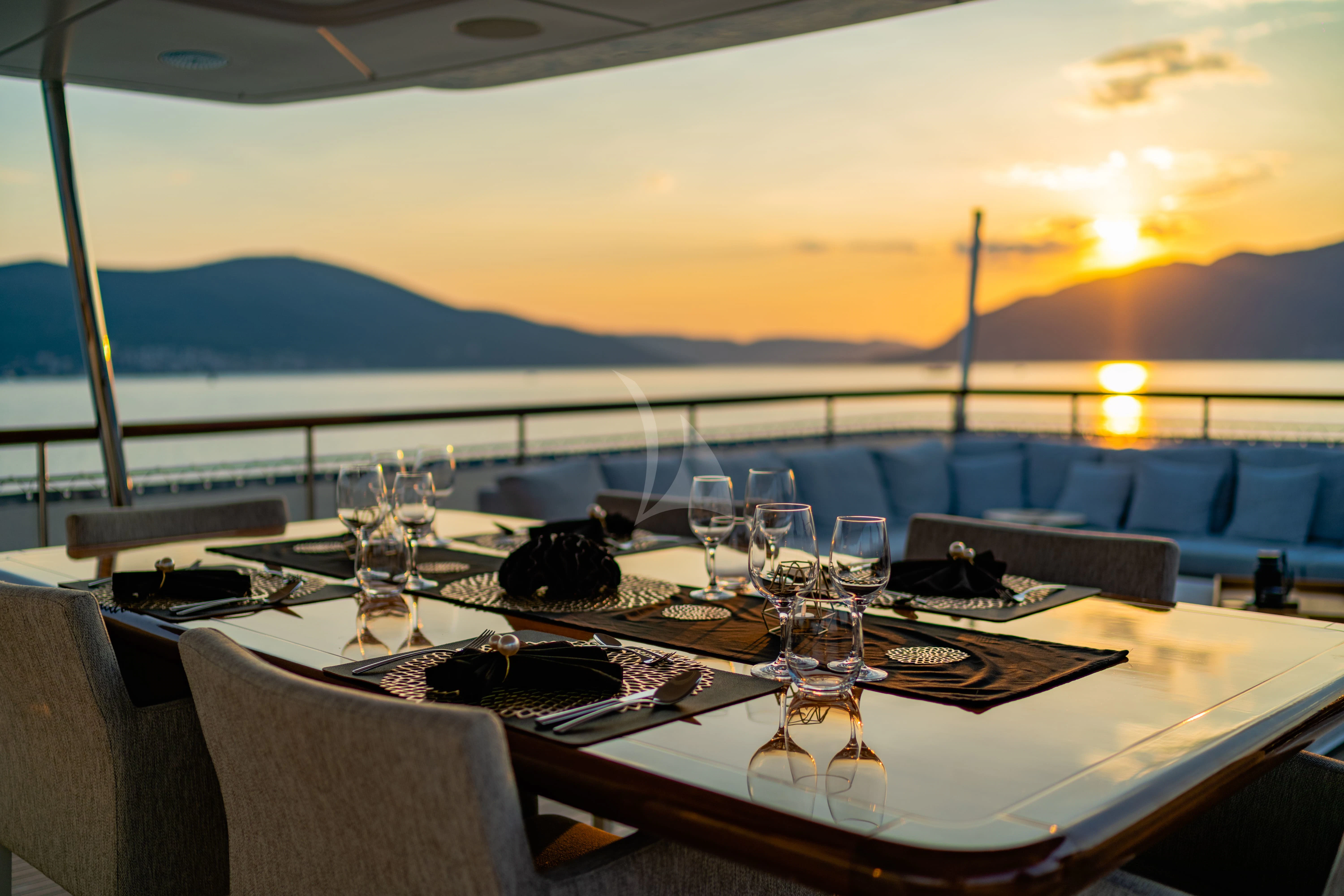 a table with wine glasses on it aboard VALENTINA II Yacht for Sale