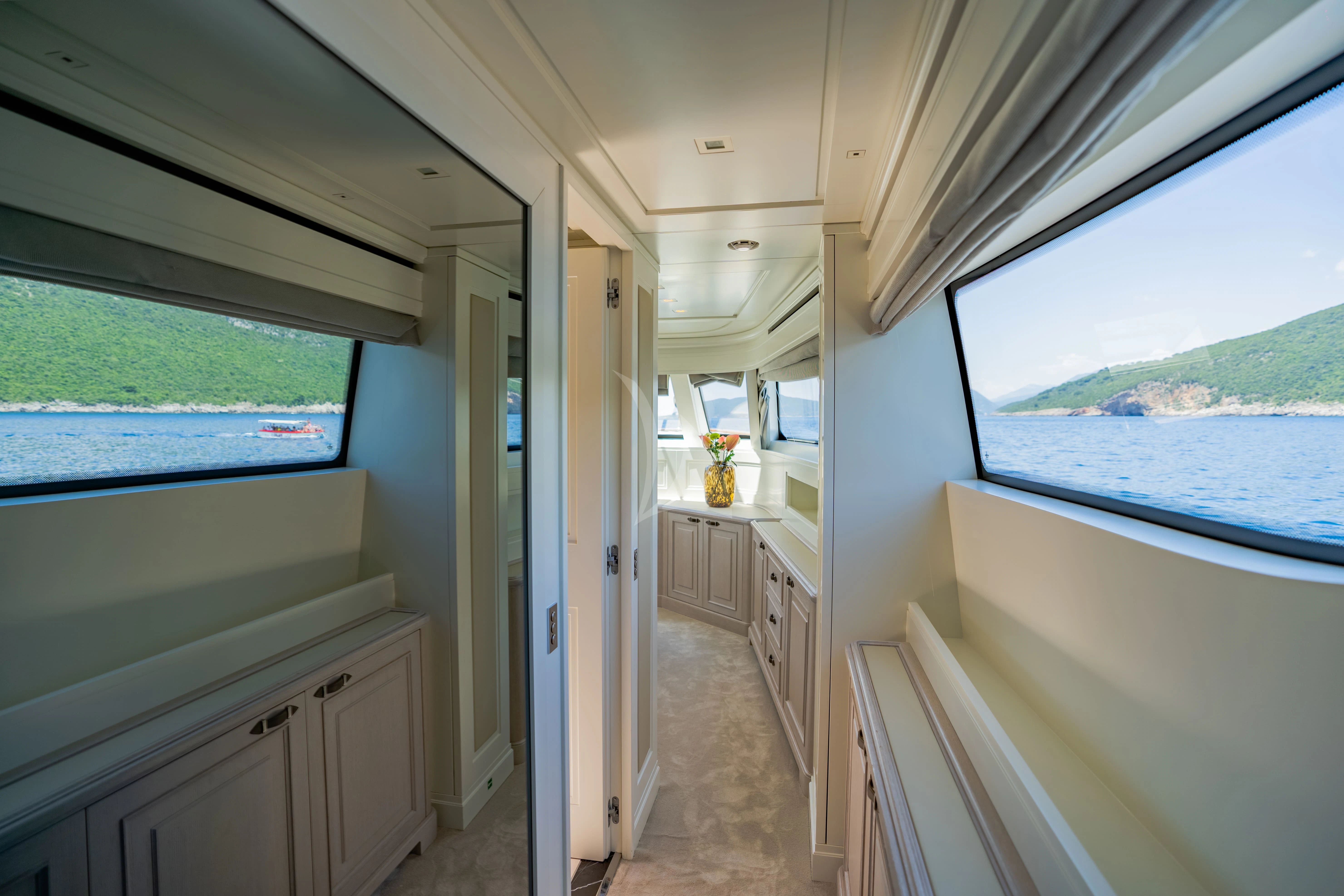 a room with a window and a view of the land aboard VALENTINA II Yacht for Sale