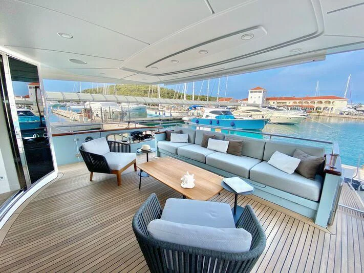 a room with a couch and a table and chairs aboard VALENTINA II Yacht for Sale