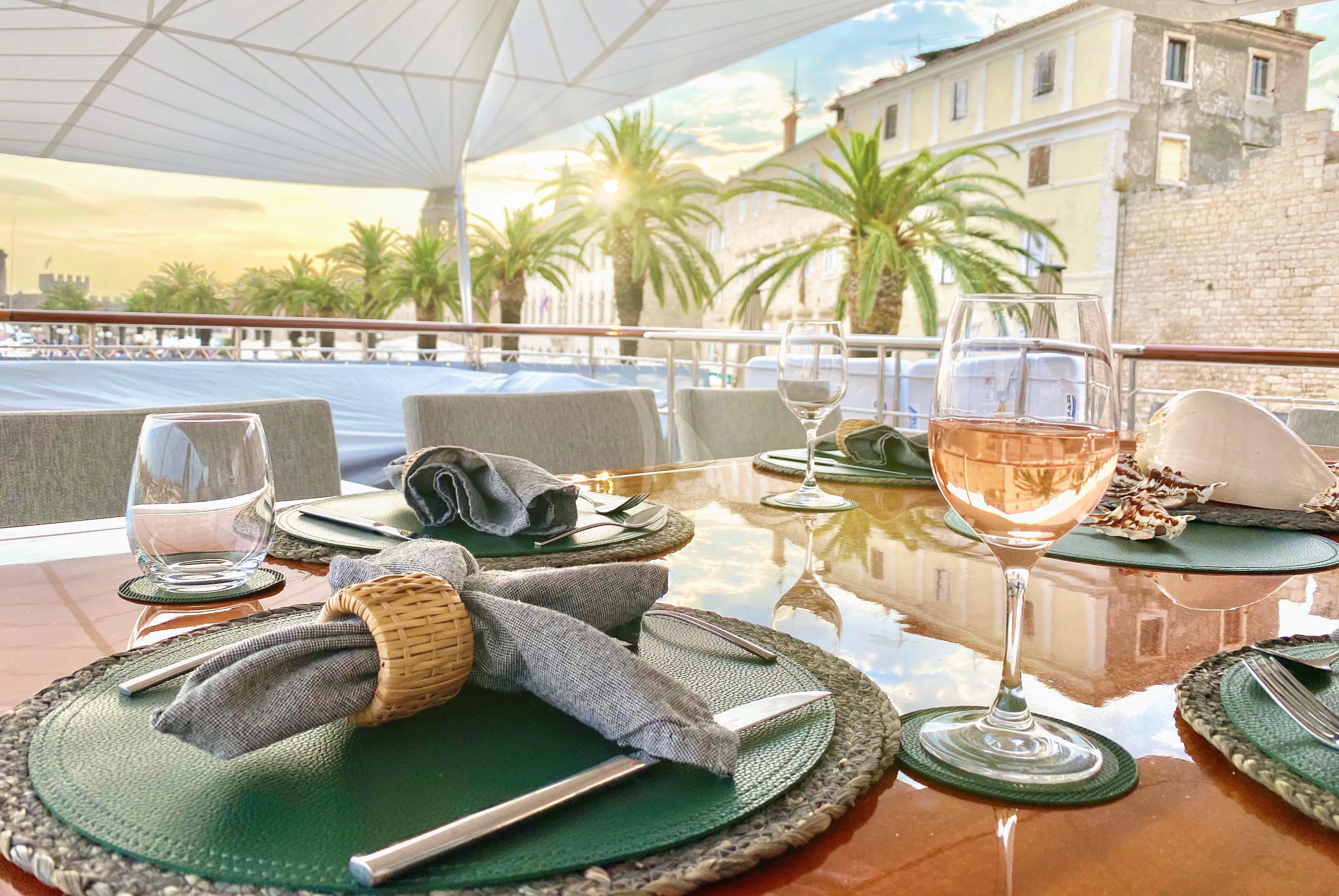 a table with food and wine aboard VALENTINA II Yacht for Sale