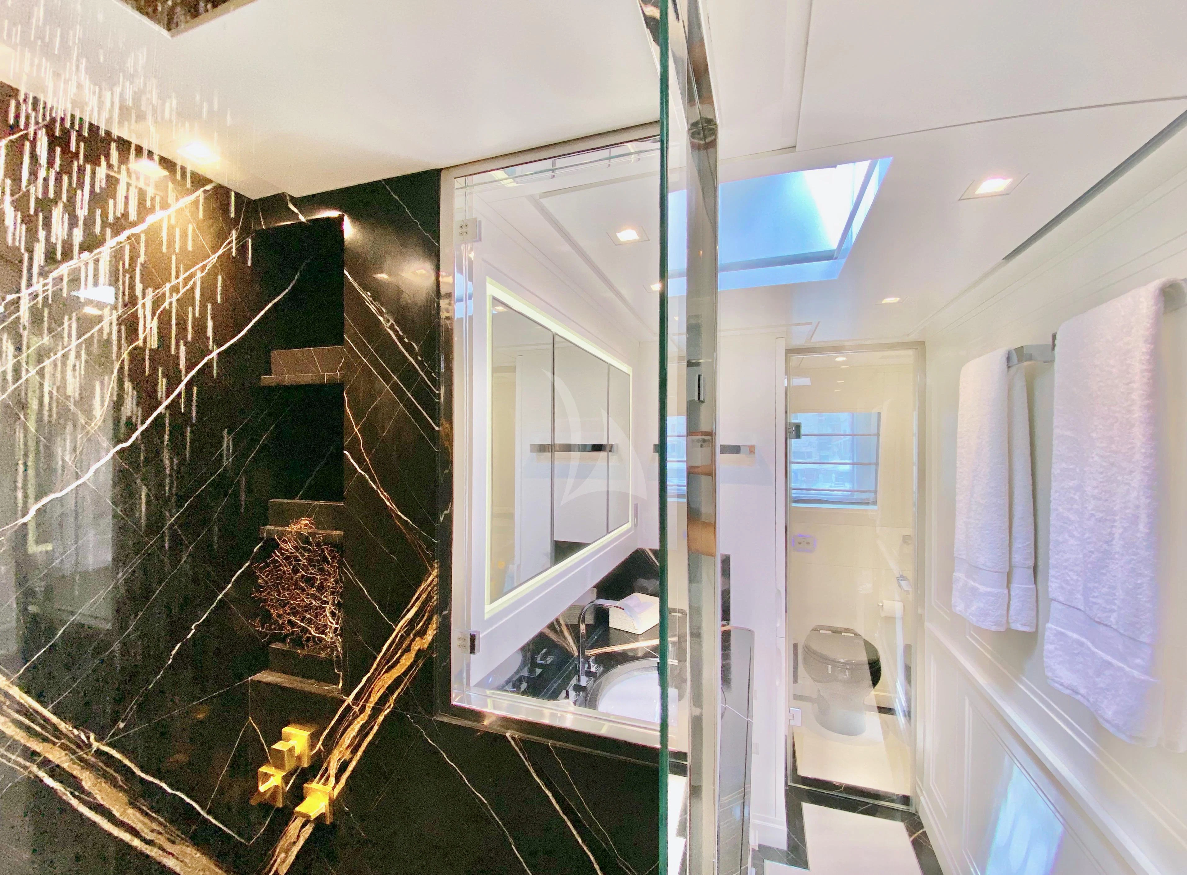 a bathroom with a mirror and a sink aboard VALENTINA II Yacht for Sale