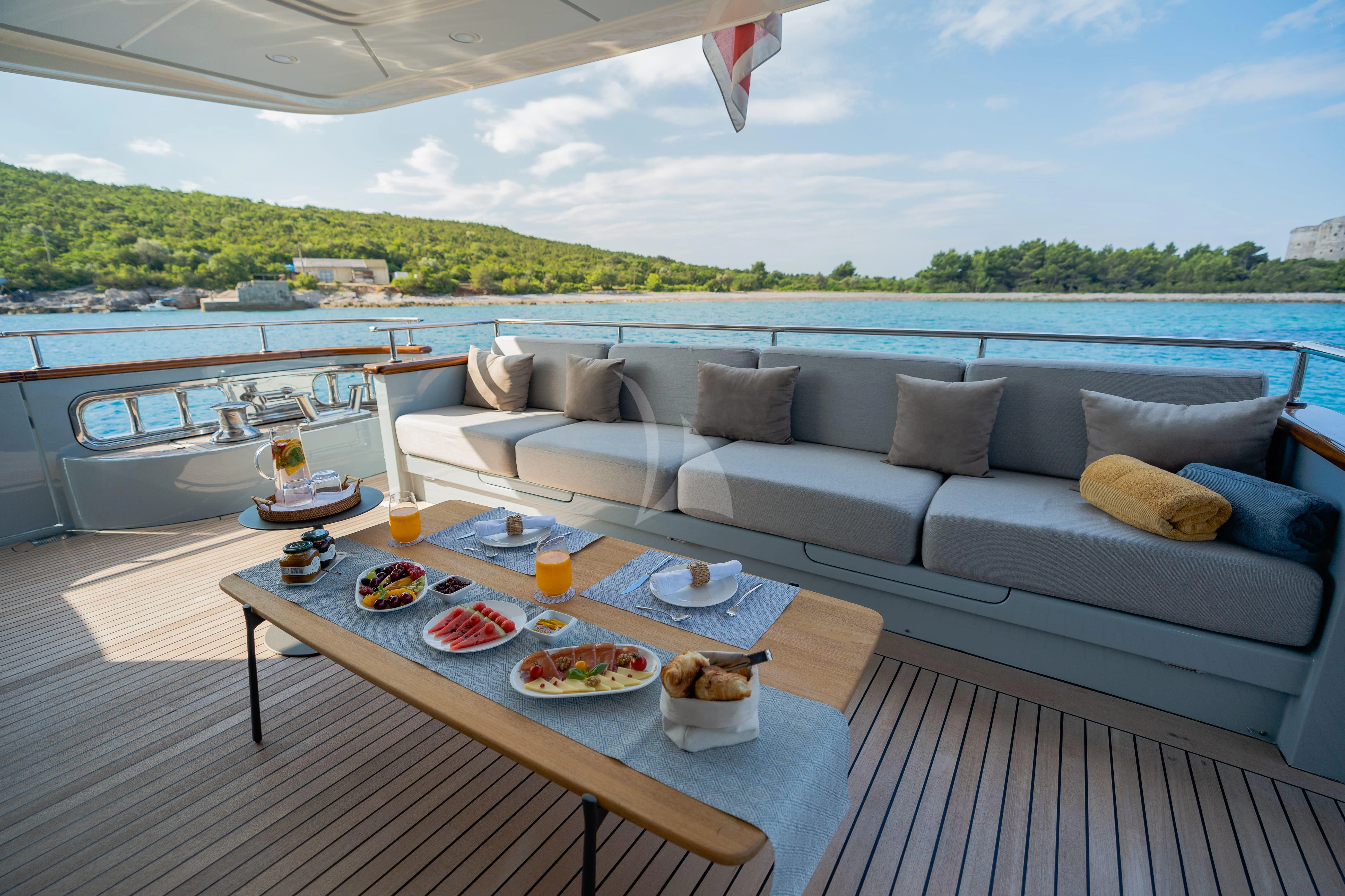 a living room with a large patio aboard VALENTINA II Yacht for Sale