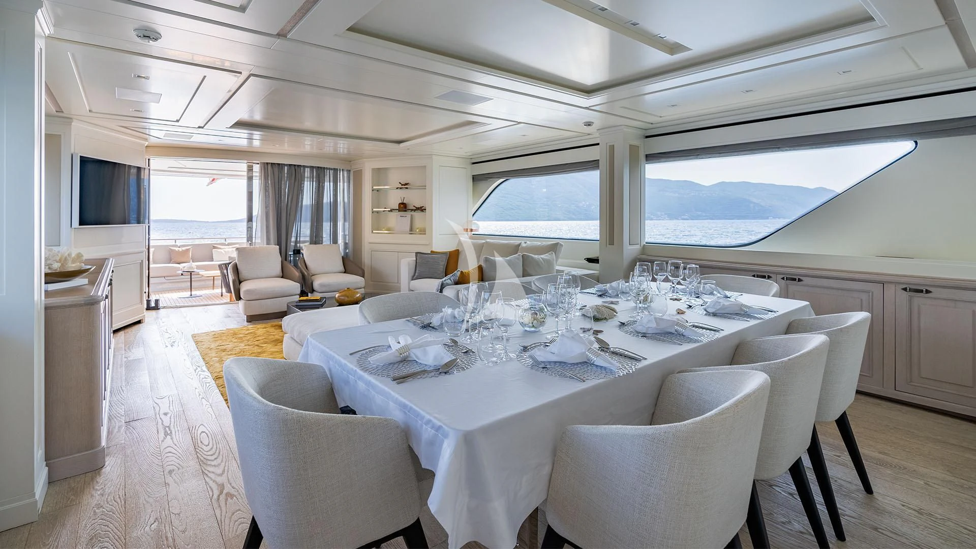 a large white dining room with a large white table and chairs aboard VALENTINA II Yacht for Sale