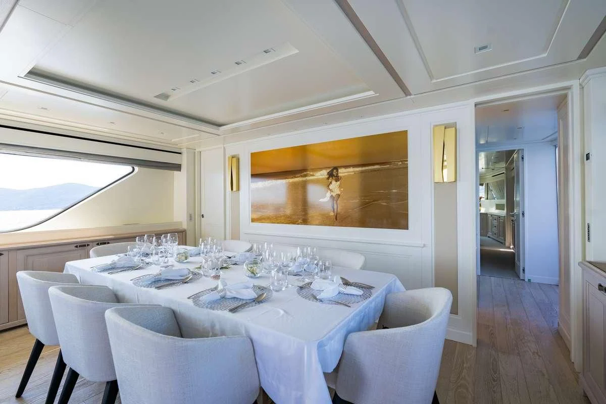 a dining room with a table and chairs aboard VALENTINA II Yacht for Sale