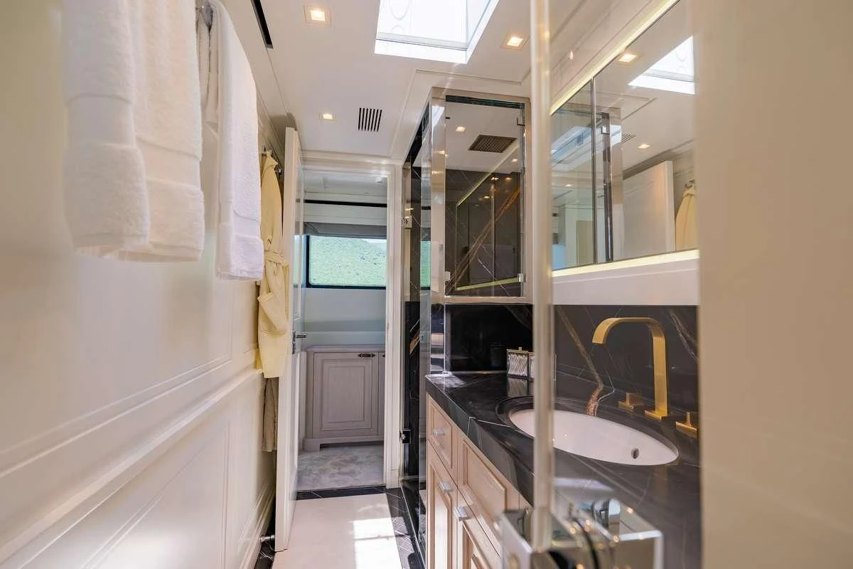 a bathroom with a sink and a mirror aboard VALENTINA II Yacht for Sale