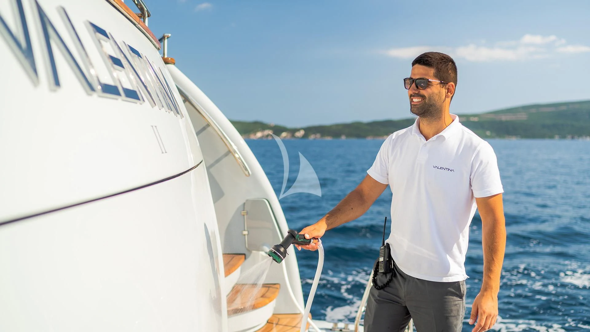 a man holding a white boat aboard VALENTINA II Yacht for Sale