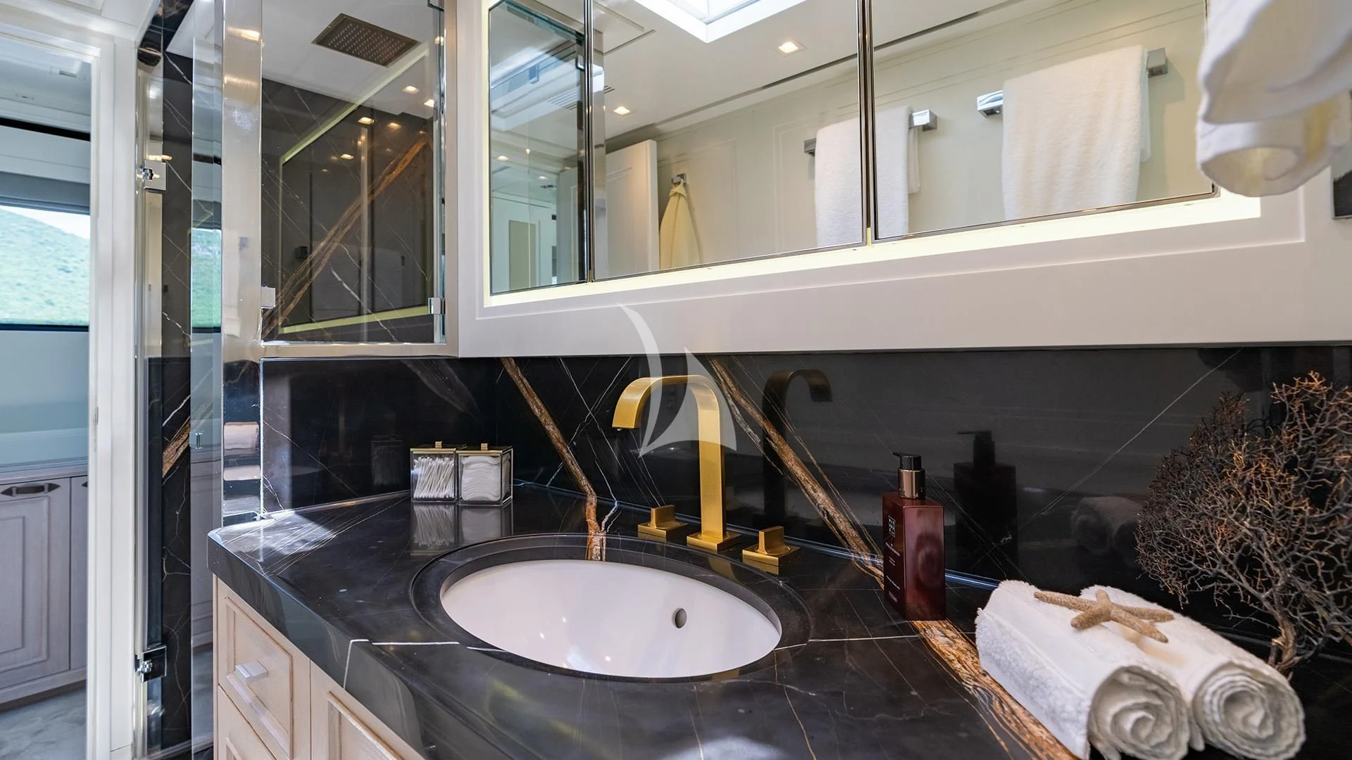 a bathroom with a sink and mirror aboard VALENTINA II Yacht for Sale