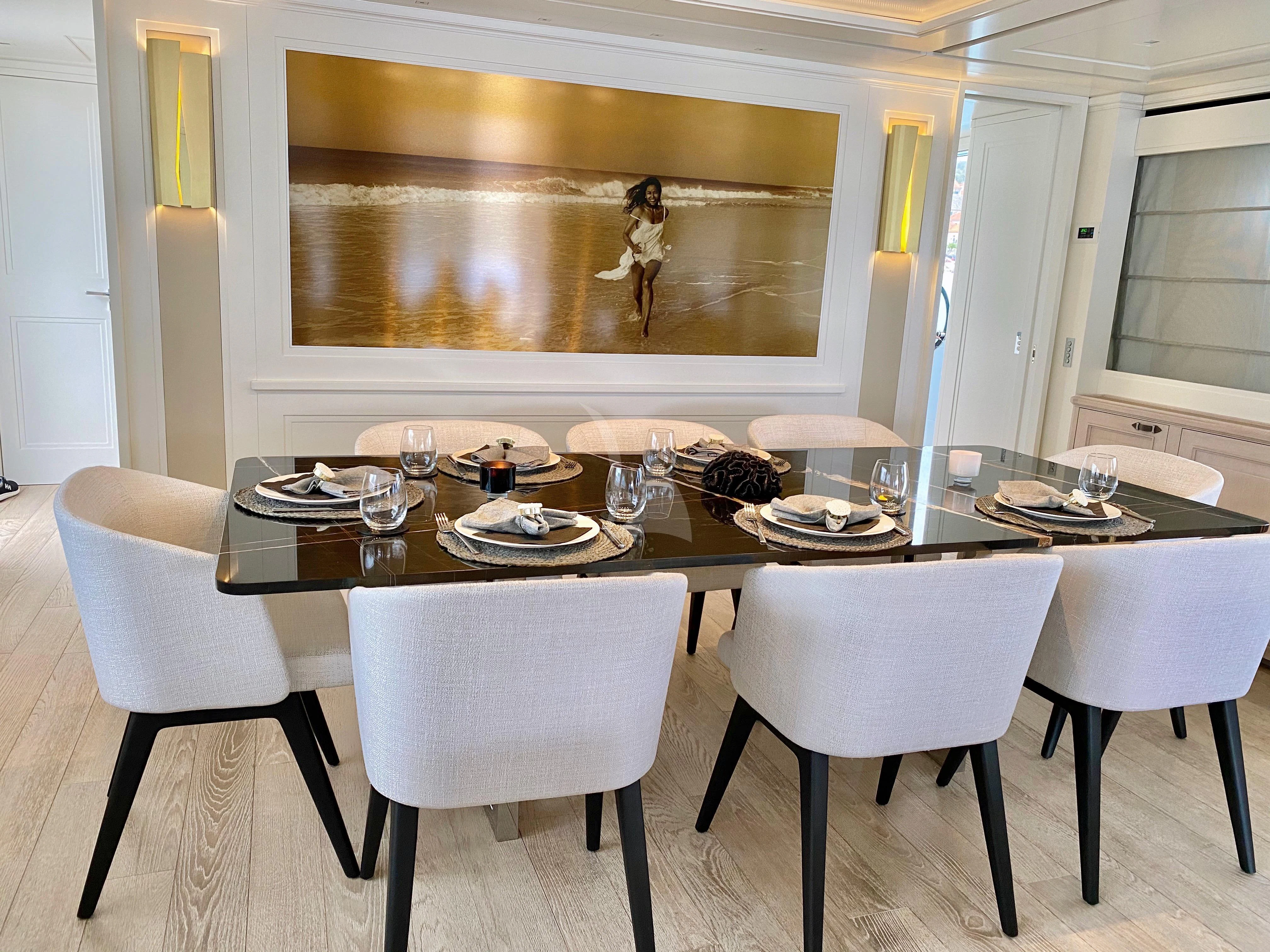 a table with plates and glasses on it aboard VALENTINA II Yacht for Sale