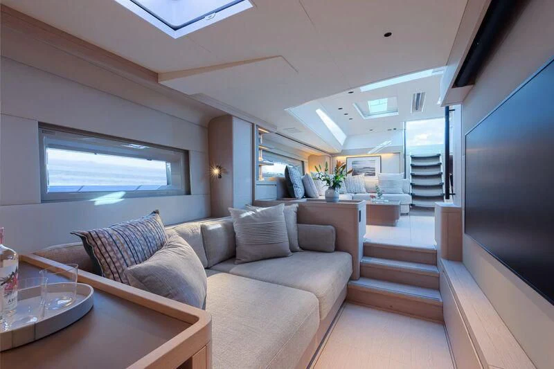 a living room with a couch and a tv aboard LIBERTY SQUARED Yacht for Sale