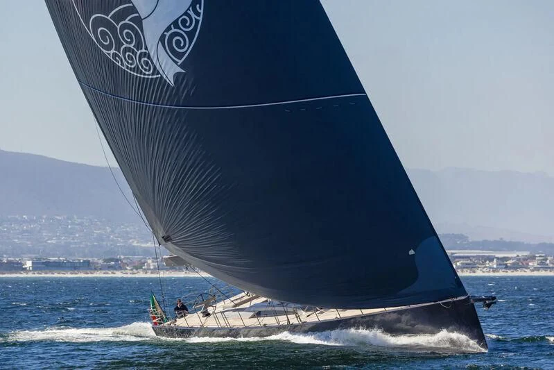 a large black and white sailboat aboard LIBERTY SQUARED Yacht for Sale