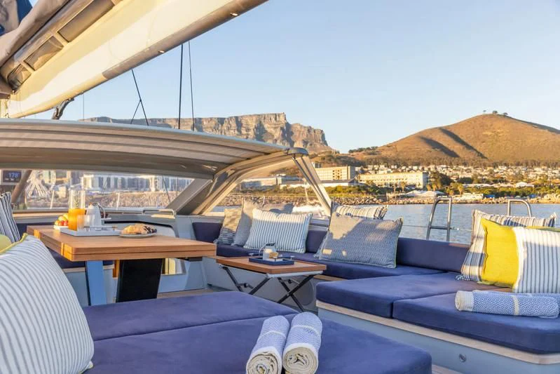 a room with a table and chairs aboard LIBERTY SQUARED Yacht for Sale