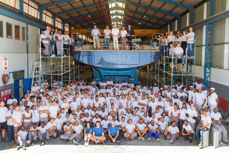 a large group of people posing for a photo aboard LIBERTY SQUARED Yacht for Sale
