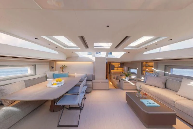 a room with a couch and a table aboard LIBERTY SQUARED Yacht for Sale