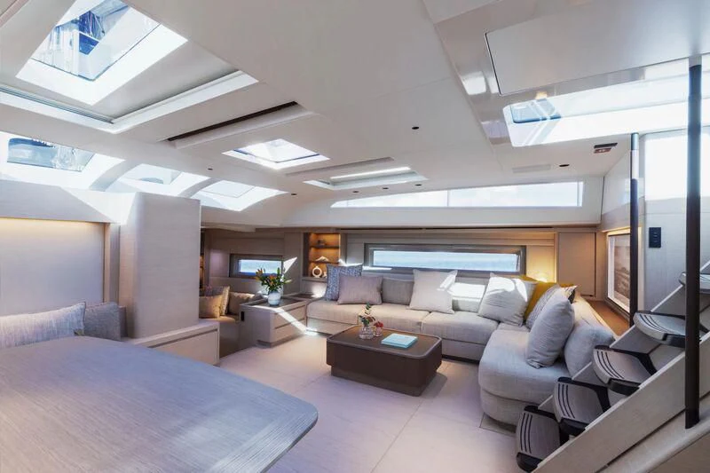 a large living room with a large bed and a large window aboard LIBERTY SQUARED Yacht for Sale