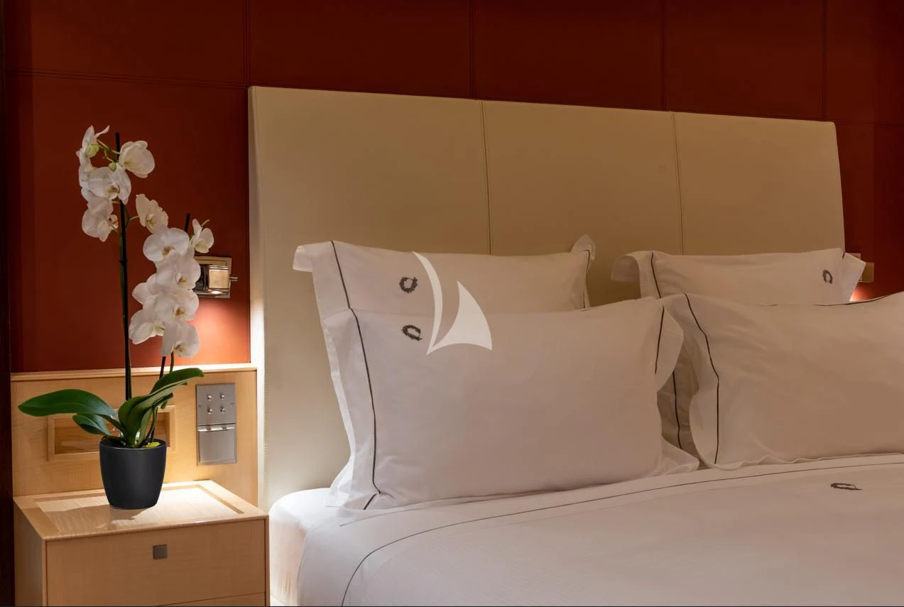 a vase of white flowers on a bed aboard VICTORIA A Yacht for Charter