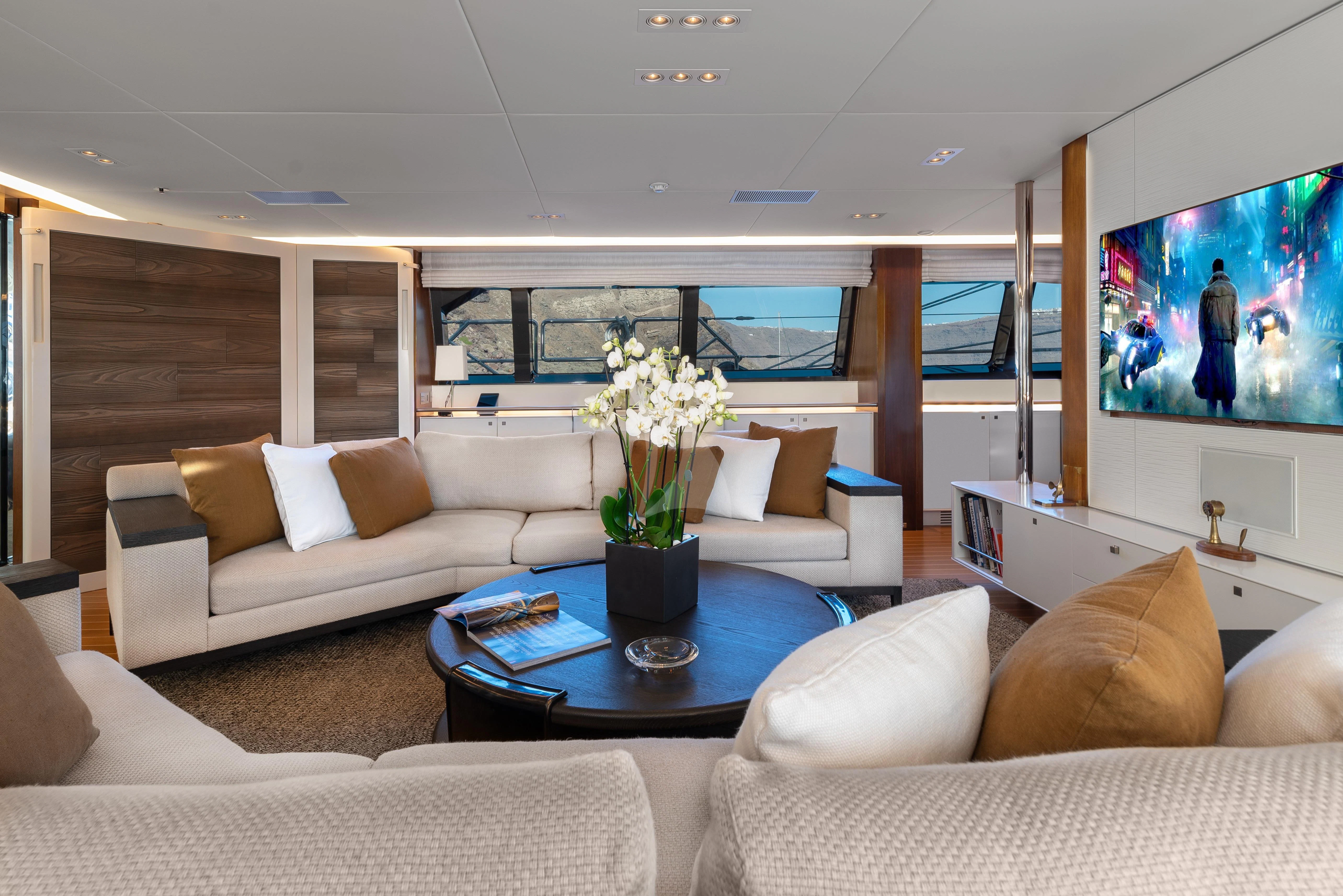 a living room with a large window aboard VICTORIA A Yacht for Charter