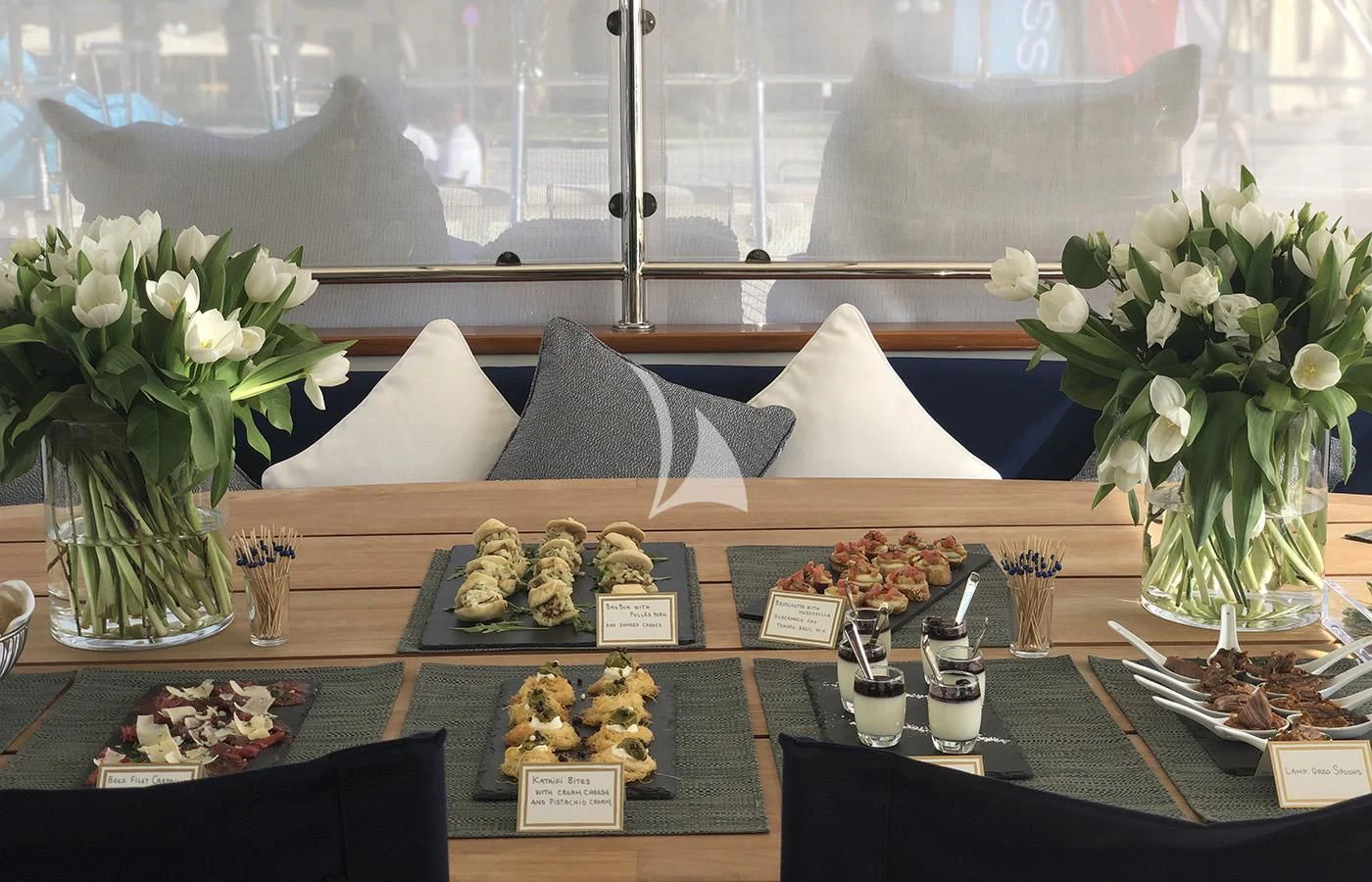 a table with food and flowers aboard VICTORIA A Yacht for Charter