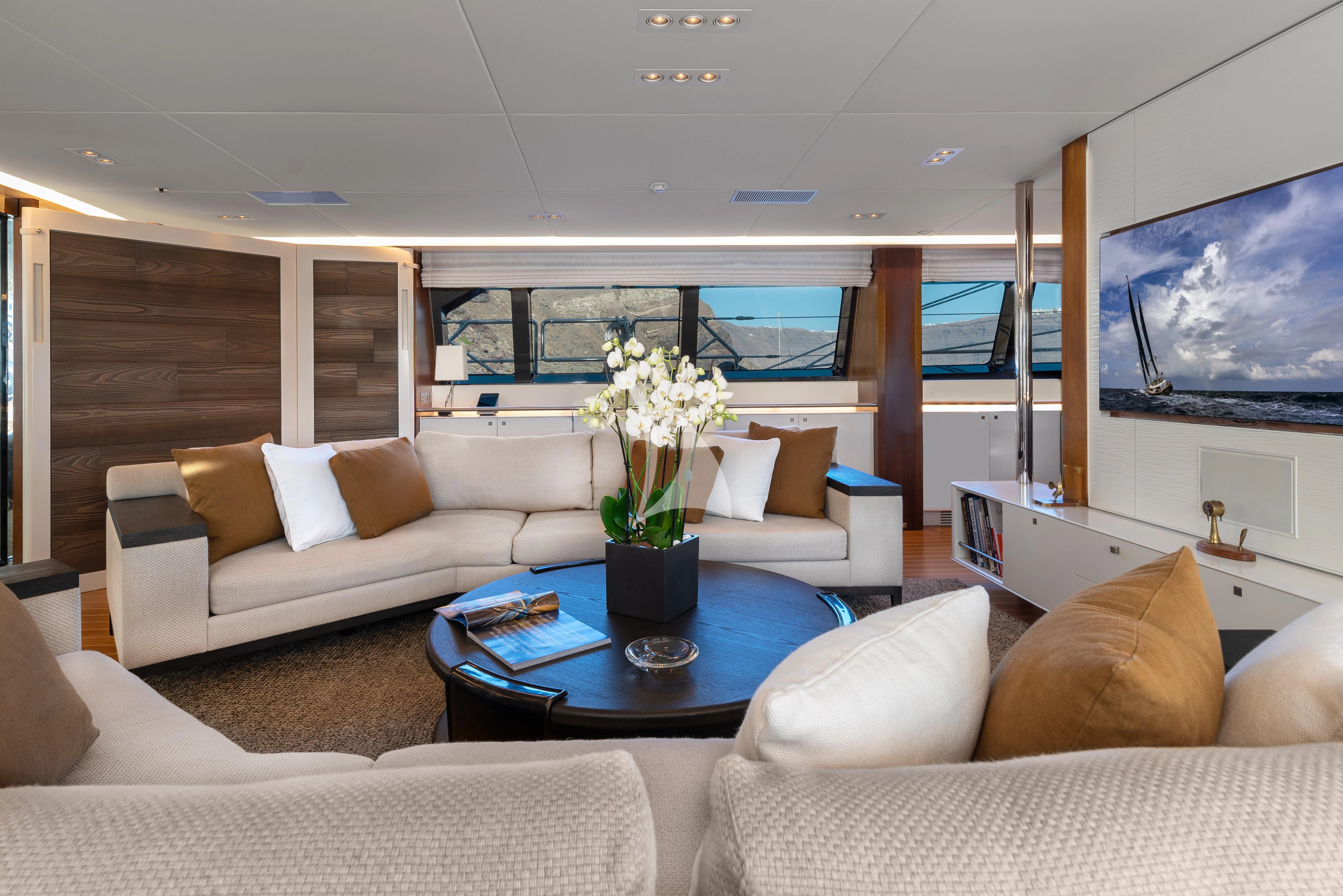 a living room with a large screen aboard VICTORIA A Yacht for Charter