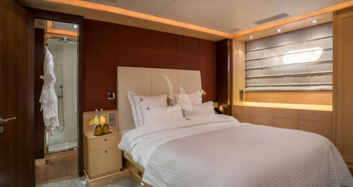 a bedroom with a bed and a closet aboard VICTORIA A Yacht for Charter