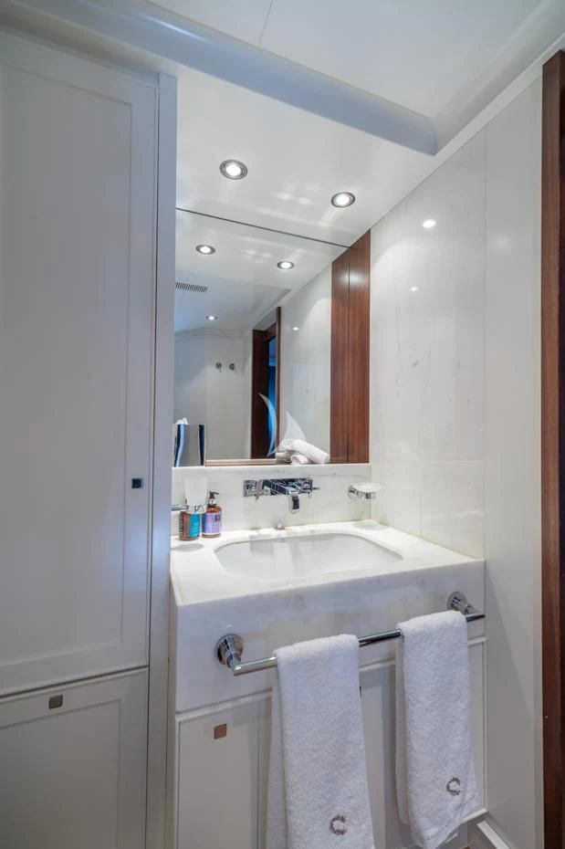 a bathroom with a sink and a mirror aboard VICTORIA A Yacht for Charter