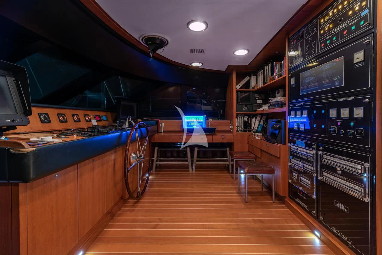 a room with a pool table and chairs aboard VICTORIA A Yacht for Charter