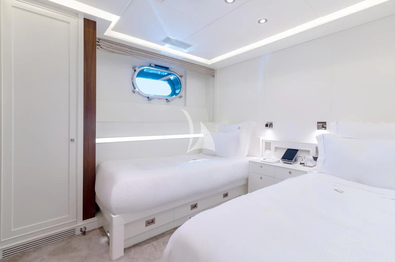 a room with white beds aboard VICTORIA A Yacht for Charter