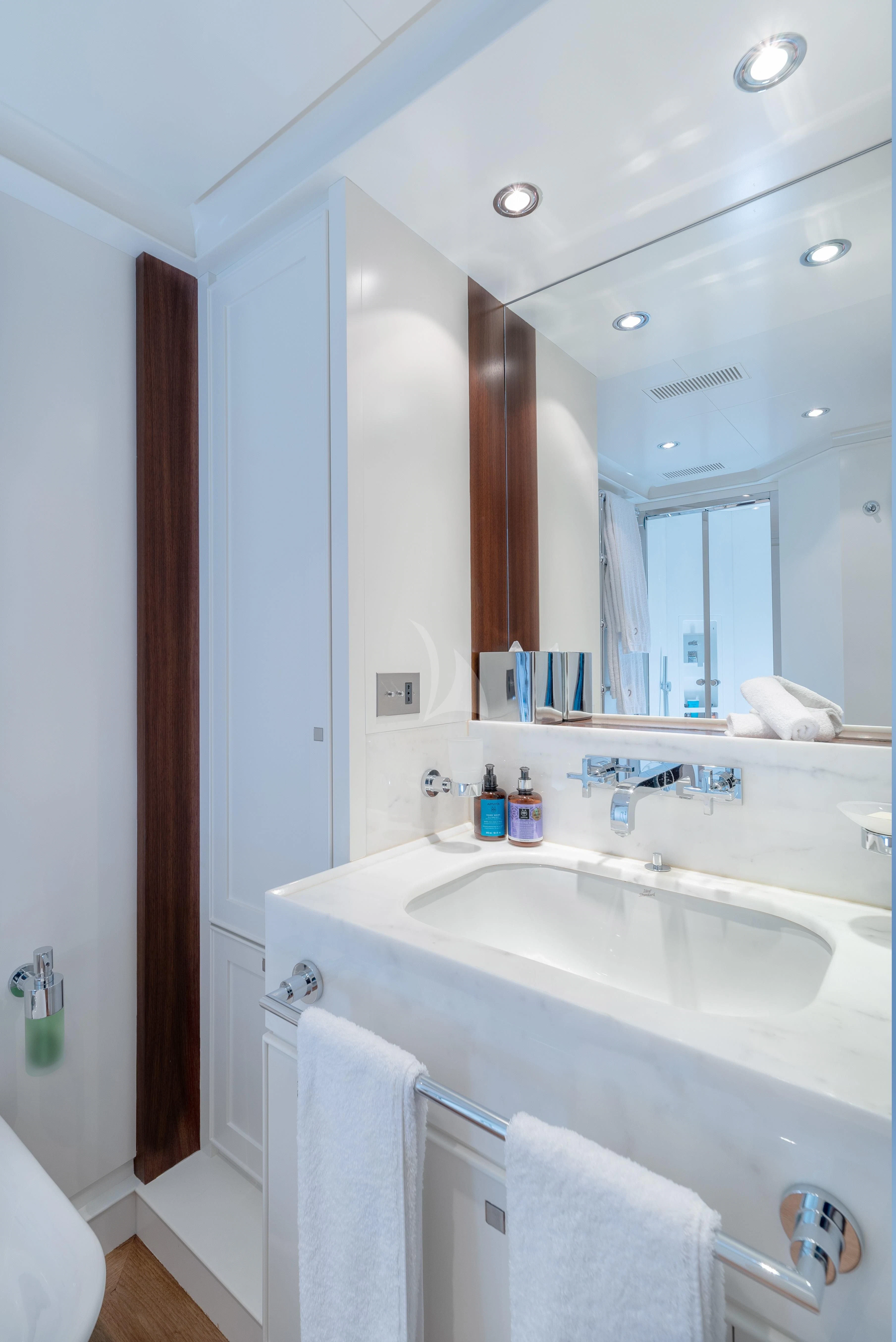 a bathroom with a sink and a mirror aboard VICTORIA A Yacht for Charter