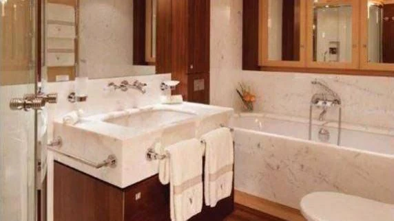 a bathroom with a bathtub and sink aboard VICTORIA A Yacht for Charter