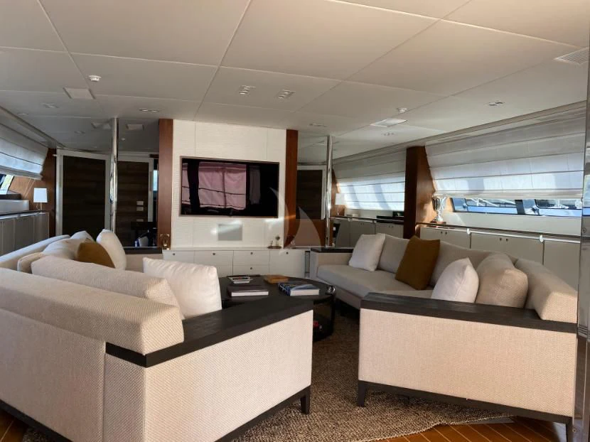 a living room with a large screen aboard VICTORIA A Yacht for Charter